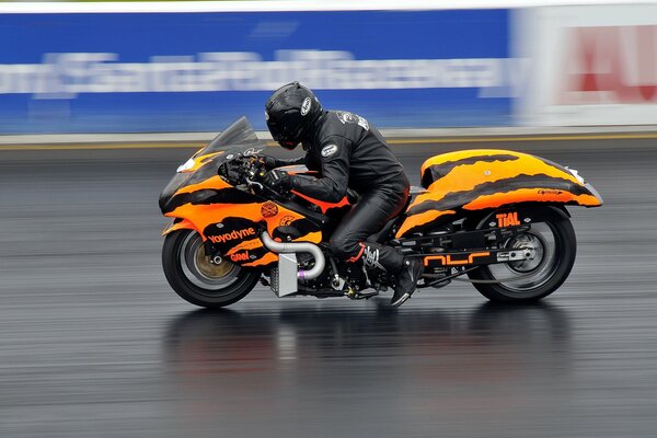 Orange motorcycle in motion on the highway