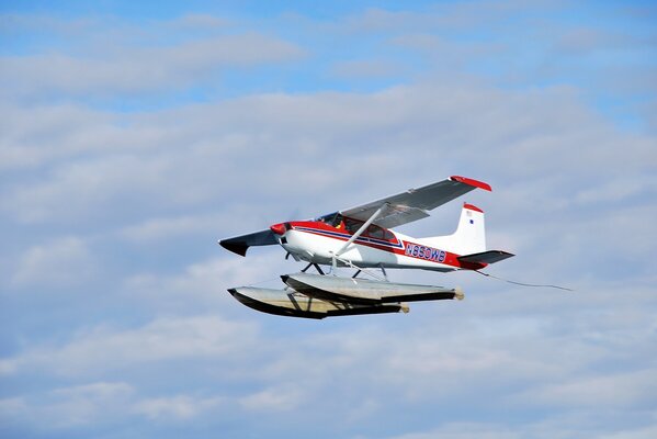 Cessna a 185f single-engine aircraft soars in the blue sky