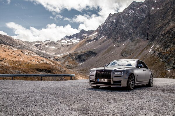 Luxury silver car on the background of mountains