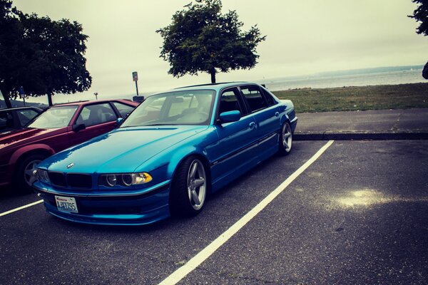 High-speed tuning BMW E38 in the parking lot