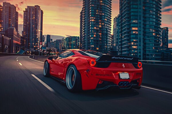 Freedom. walking around the city at sunset in a red ferrari italia rear view