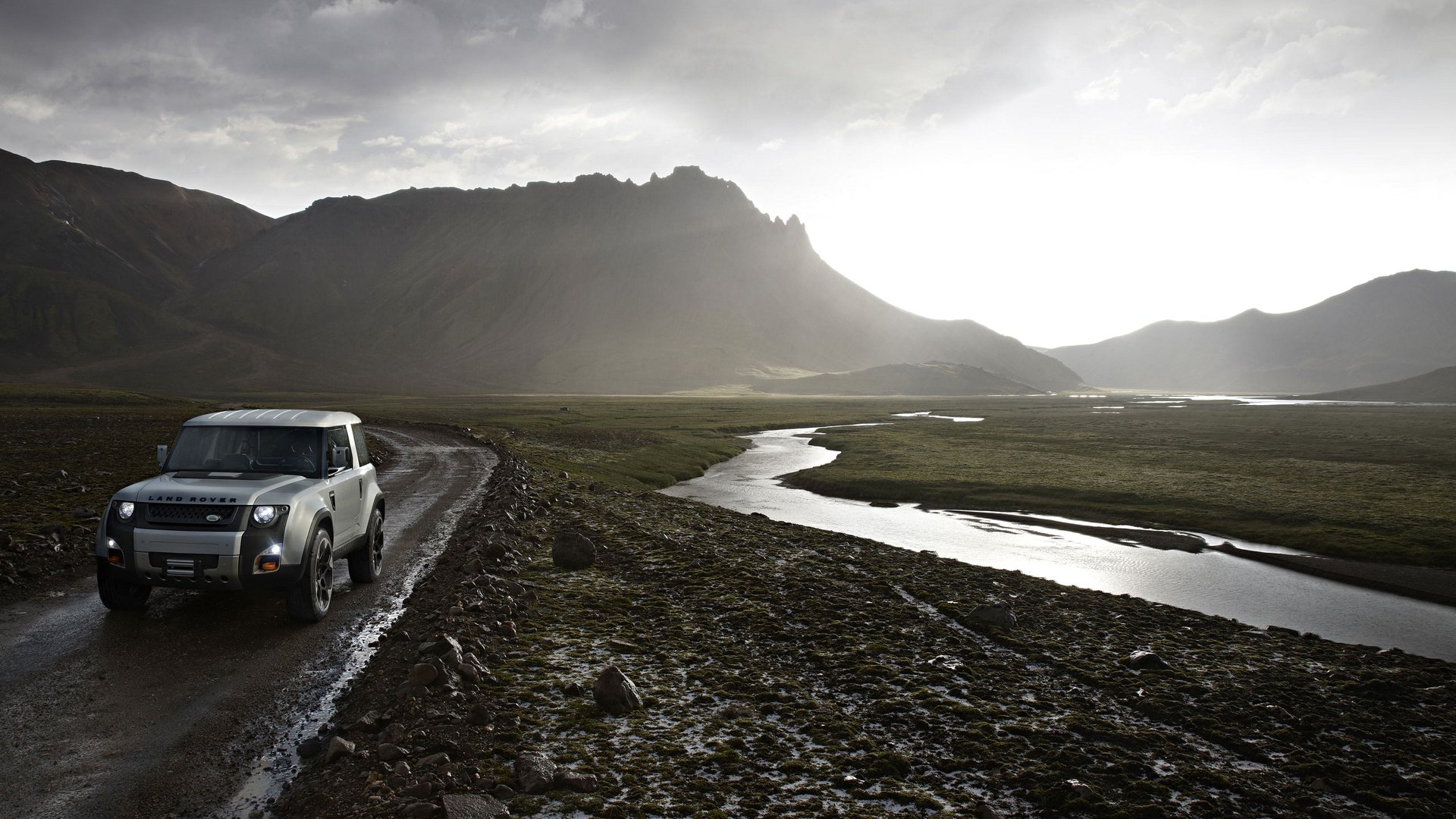 land rover dc100 mountain landscape road creek