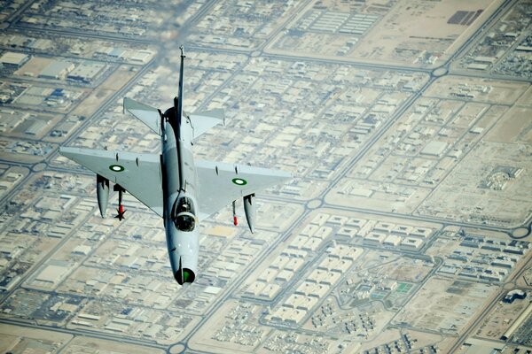 A Chinese fighter jet is flying over the city