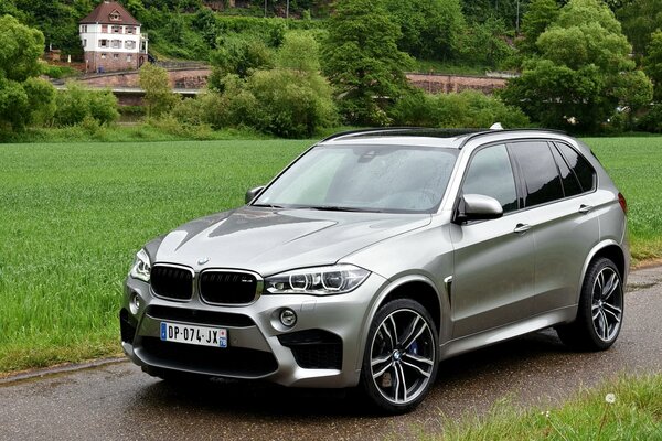 BMW x5m on the background of houses