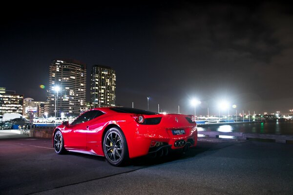 Roter Ferrari auf Nacht Stadt Hintergrund