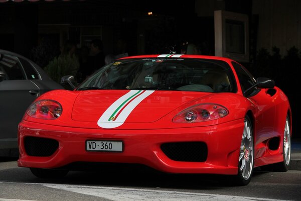 Red with a white stripe on the hood of the Ferrari