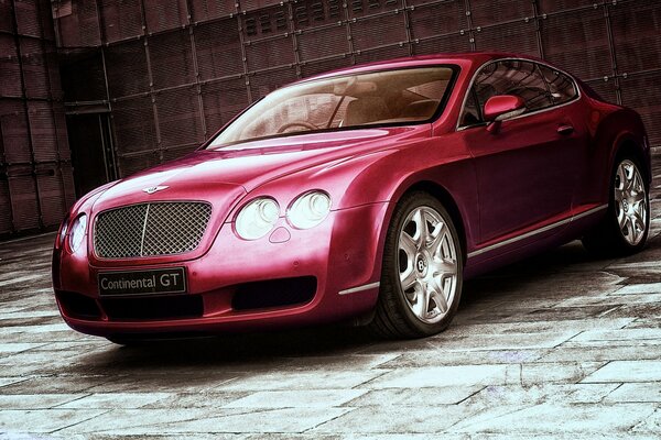 Bentley continental rouge sur fond de mur