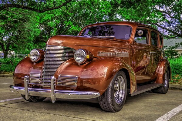 A vintage car is parked in the parking lot