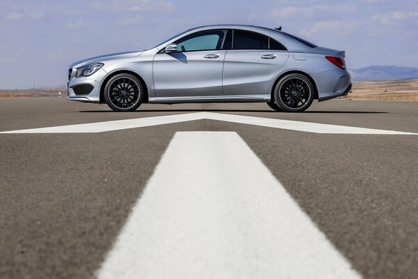 Mercedes-benz grey sedan side view on asphalt