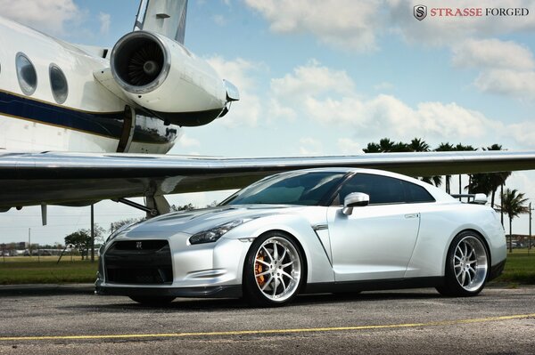 Sports car on the background of an airplane