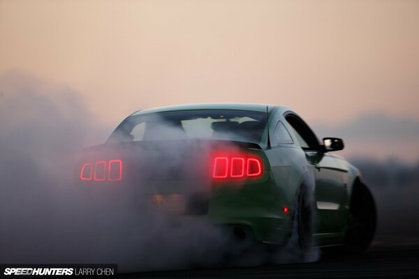 High-speed Ford Mustang on the background of sunset