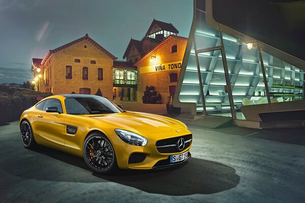 Yellow Mercedes supercar on the background of the old town