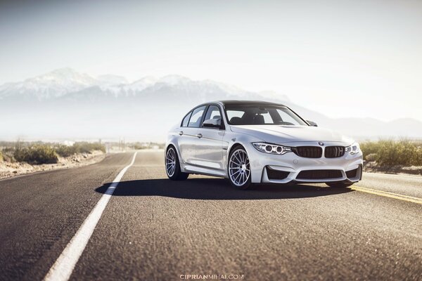 Bmw m3 on the background of an asphalt road