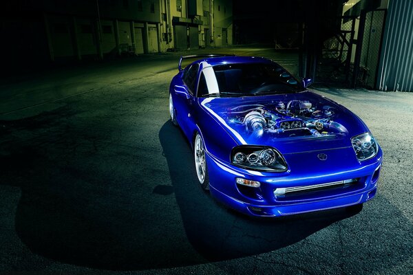 Toyota supra is blue, the engine is visible