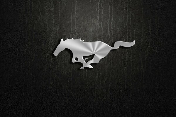 Silver mustang logo on black background