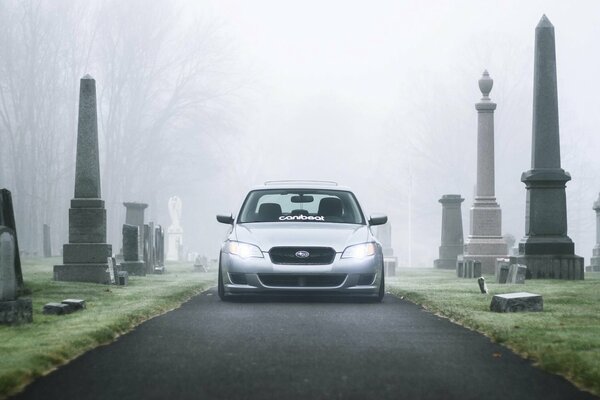 Silver Subaru at the cemetery in the fog