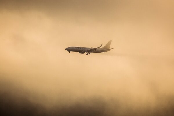 The plane makes its way through thick clouds