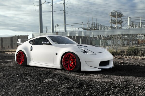 Nissan pedigrees red wheels, and he is white