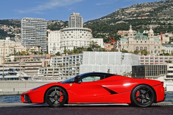 Red Ferari on the background of a beautiful city