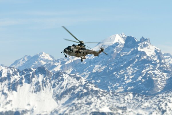 Helicopter on the background of beautiful white mountains