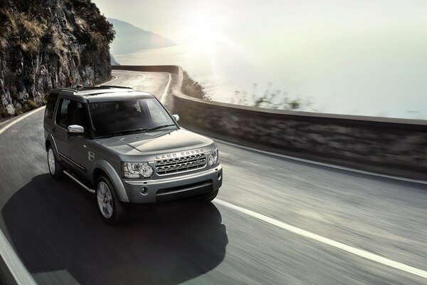 The road to the sea. Gray jeep SUV land rover