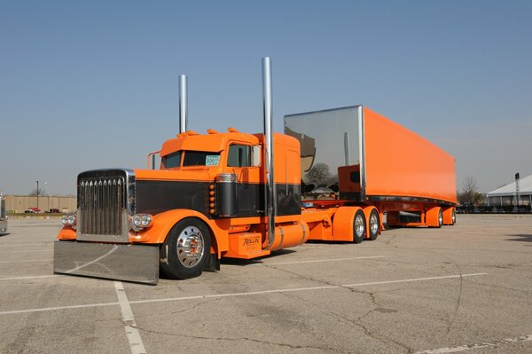 Big orange truck on asphalt