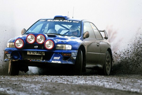 Voiture bleue sur une route boueuse