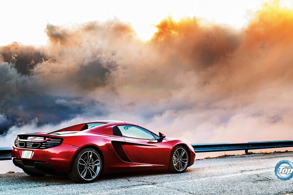 Red McLaren driving on the highway