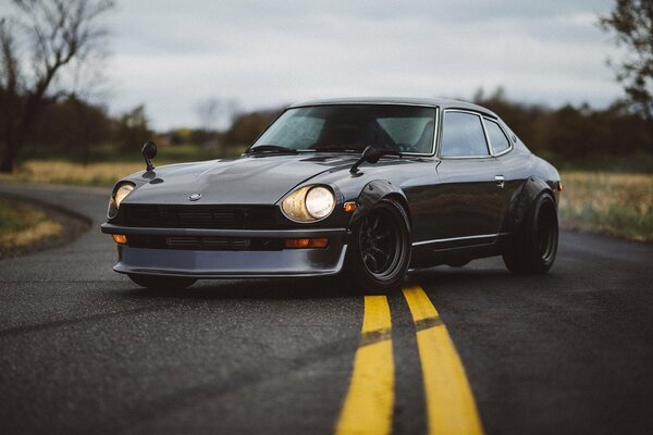 Beautiful dark Nissan on the background of autumn