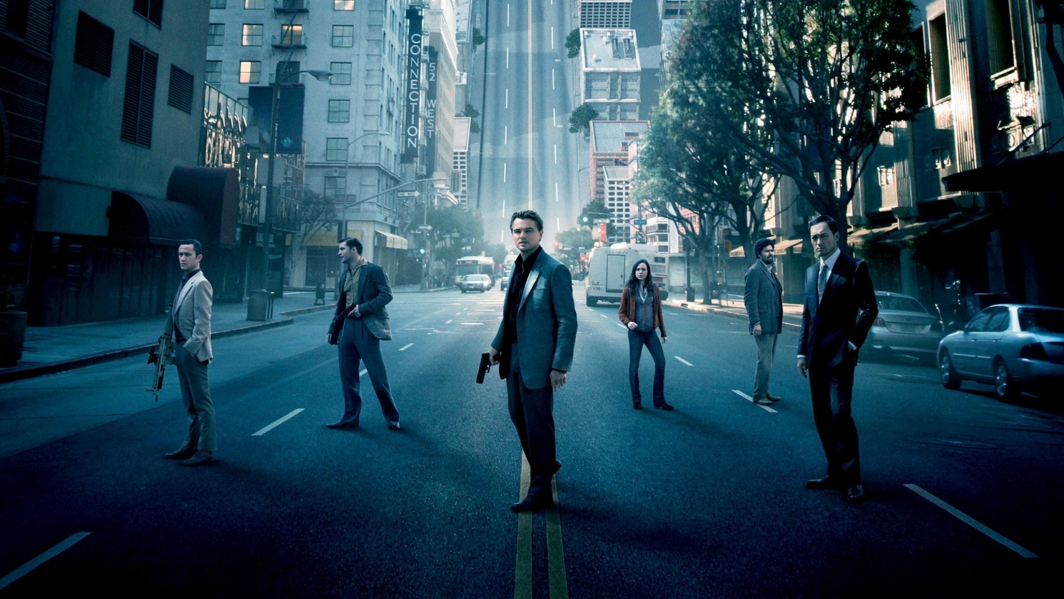 beginning inception actors stand city buildings street cars trees dream movie actors cinema