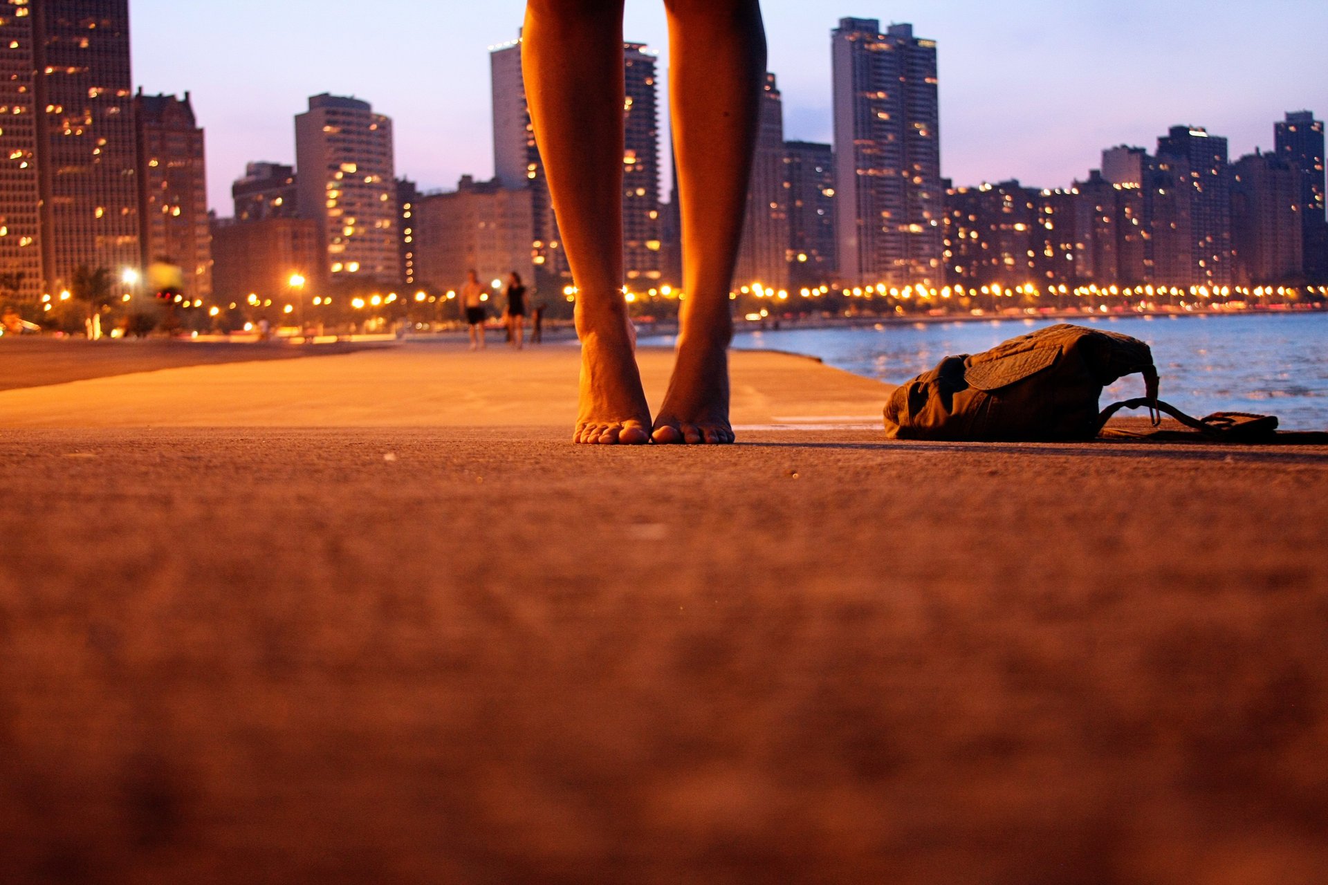 legs arrived bag city lights road water river embankment people lanterns skyscrapers city light