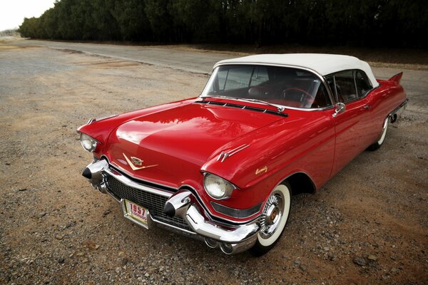 Vintage red Cadillac car with a white convertible