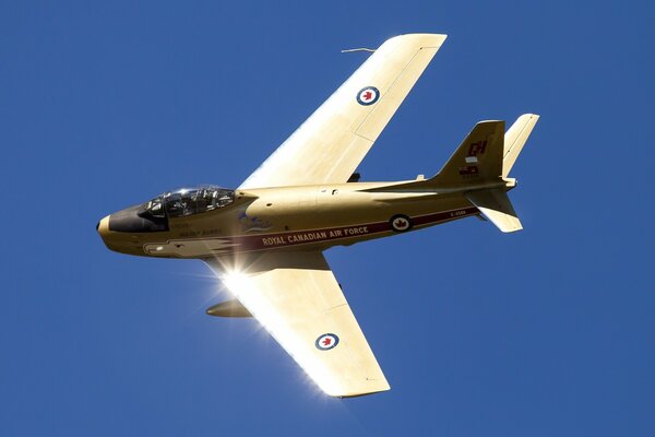 A brilliant fighter jet against a clear sky