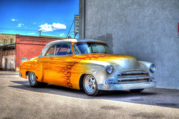 A picture of a retro car with a fiery pattern