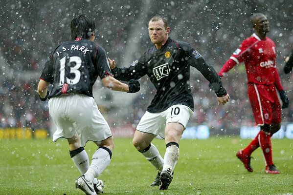 Football in the rain, playing on the field