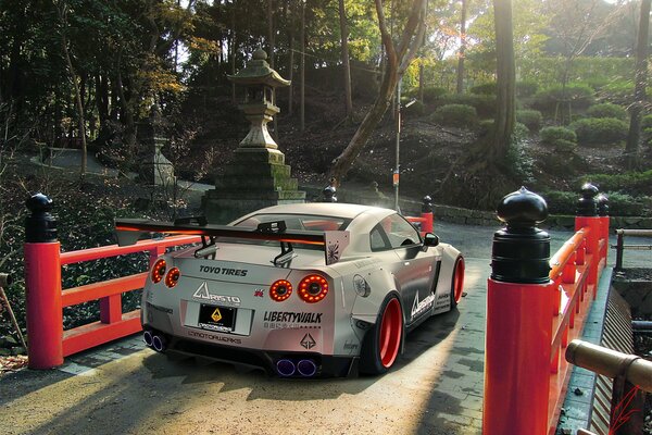 A sports car overcomes a Japanese-style bridge