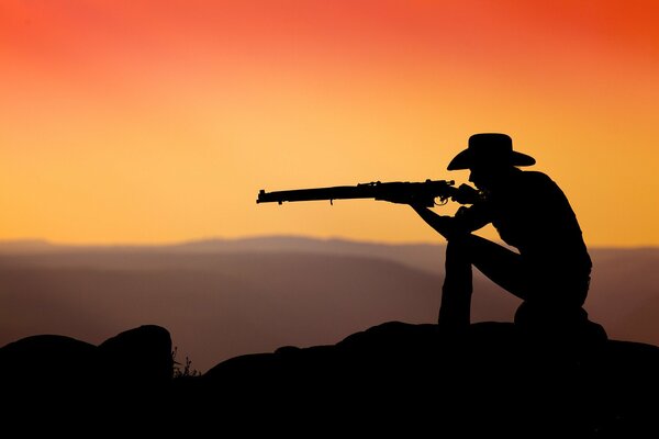 The shooter on the background of sunset