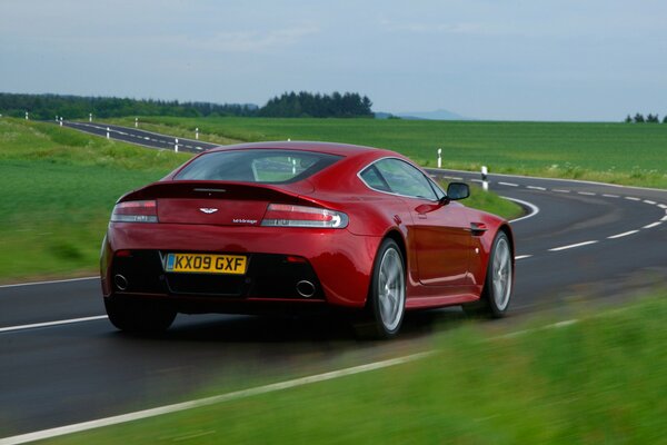 Aston Martin auto red on the highway