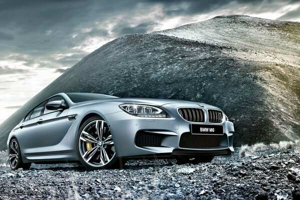 Silver gray BMW on the background of silver gray hills