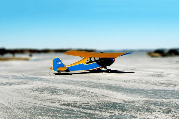 Blue and yellow airplane on the runway