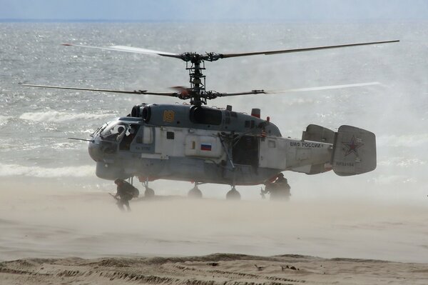 Helicopter take-off from the sea beach