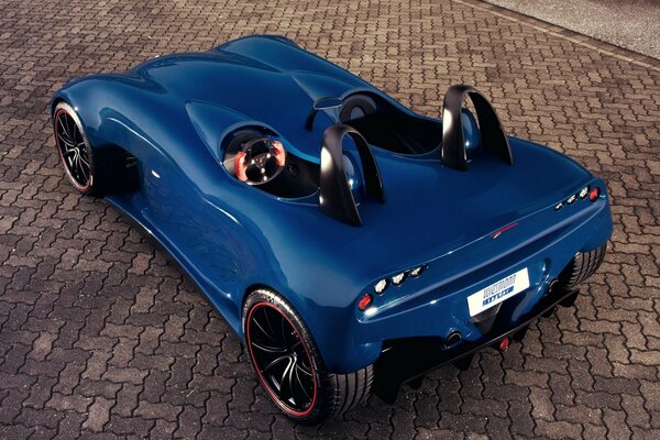 Blue concept car wiesmann, spyder on the background of paving slabs