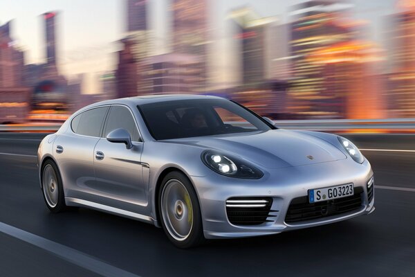 Porsche panamera with turbo speed rides around the city