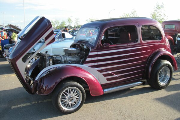 Red striped Volkswagen with black tires at auction