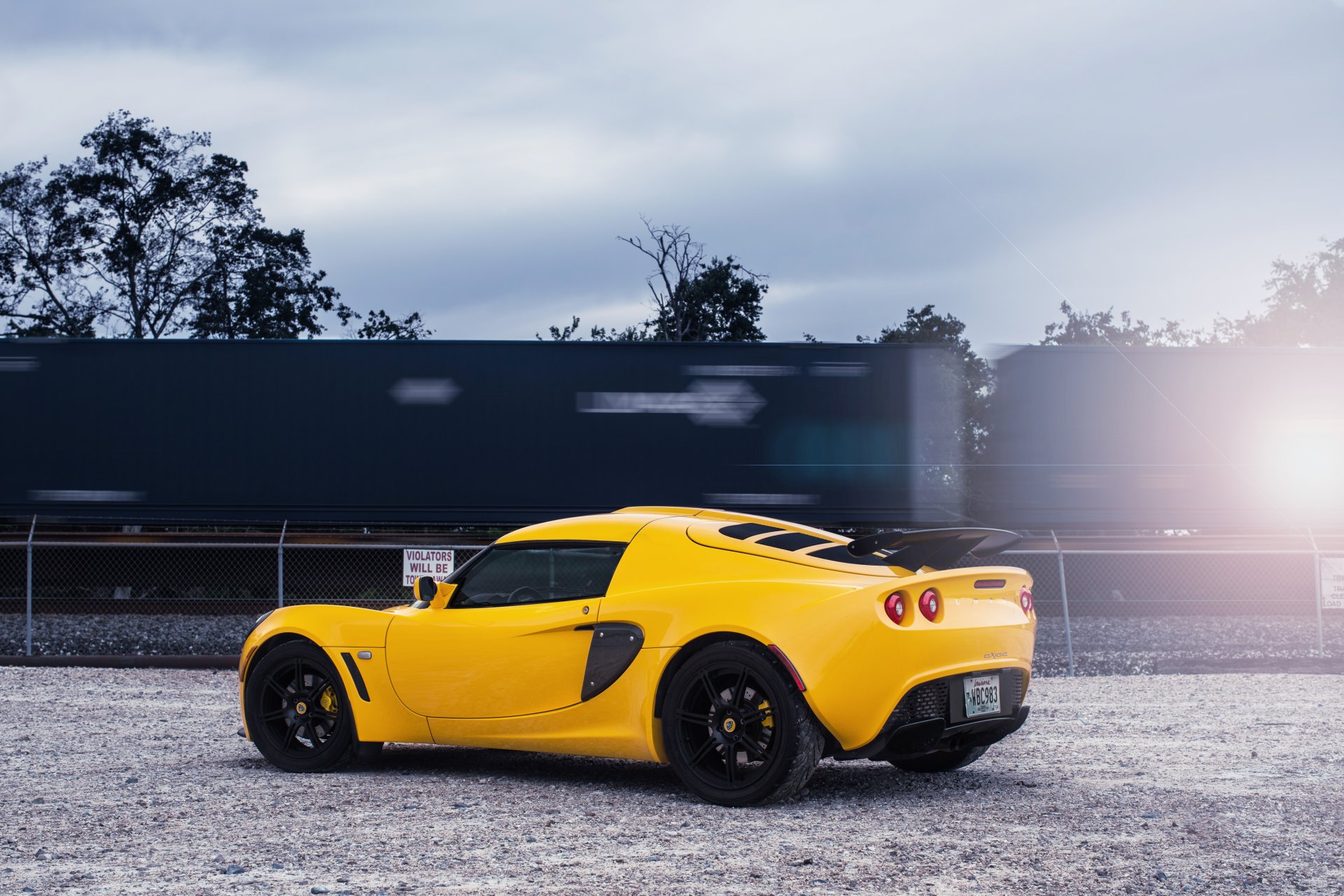 lotus exige yellow lotus exige railway sky cloud