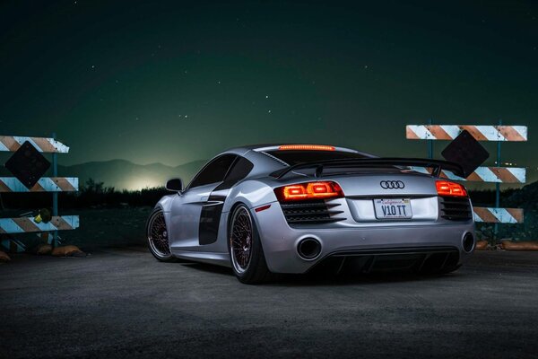 A picture of a car behind at sunset audi r8 v10