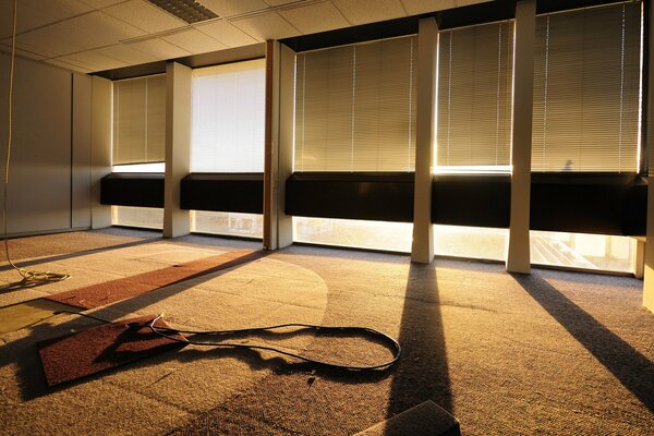 The rays of the sun make their way through the blinds in the building