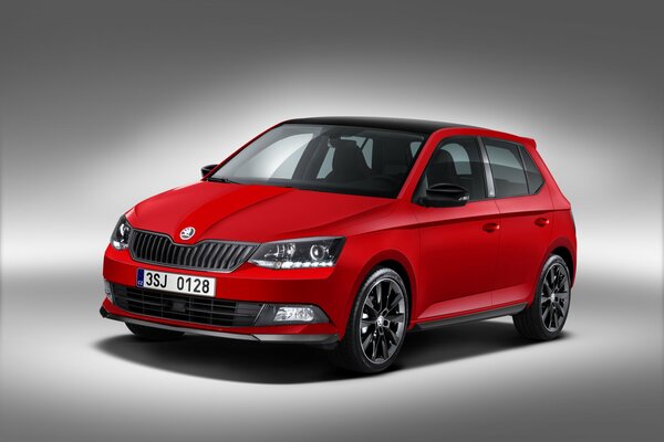 Red skoda fabia on a grey background