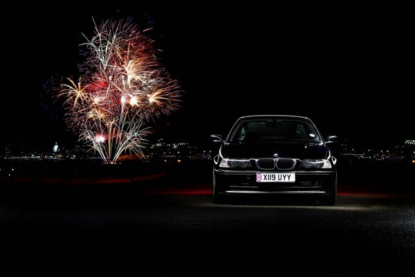 Black car on the background of fireworks