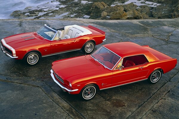 Two red cars - a Ford Mustang and a convertible